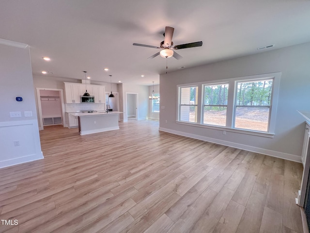 217 Duncan Creek Rd # 124, Lillington, NC 27546 - unfurnished living room featuring ceiling fan, baseboards, light wood-style flooring, recessed lighting, and a chandelier