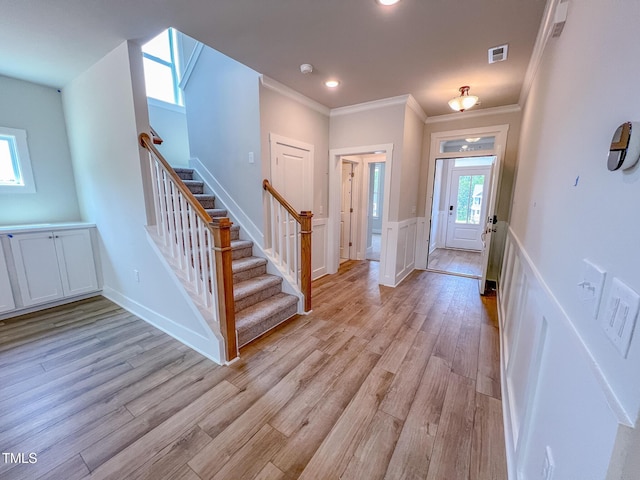 217 Duncan Creek Rd # 124, Lillington, NC 27546 - entryway featuring stairs, crown molding, light wood finished floors, a wainscoted wall, and recessed lighting