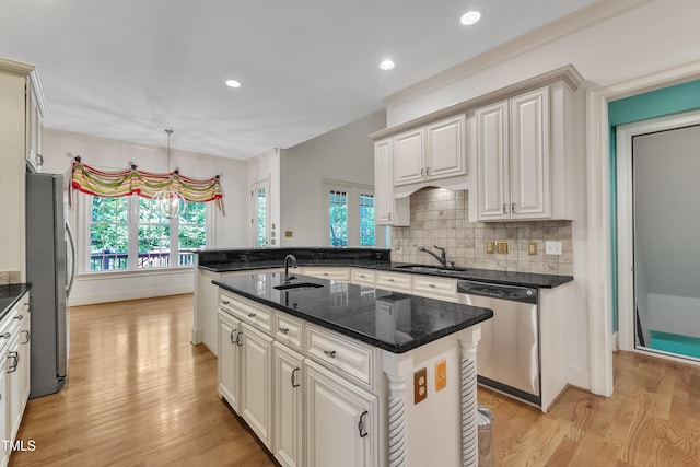 85 Christenbury Ln, Clayton, NC 27527 - kitchen with light wood-style floors, a sink, tasteful backsplash, and stainless steel appliances