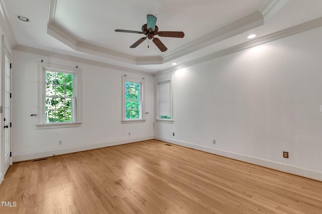 85 Christenbury Ln, Clayton, NC 27527 - empty room featuring a ceiling fan, baseboards, light wood-type flooring, a tray ceiling, and ornamental molding