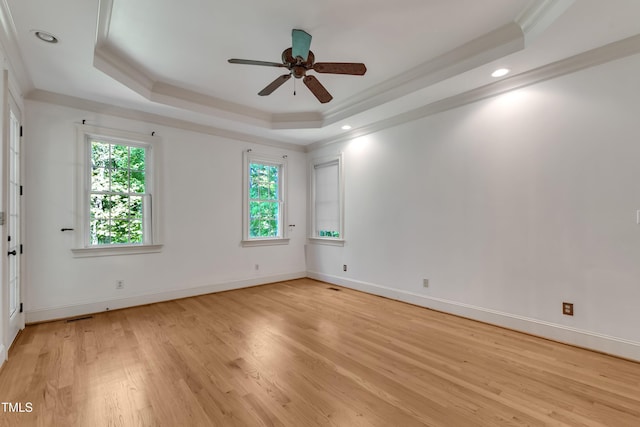 85 Christenbury Ln, Clayton, NC 27527 - empty room featuring a ceiling fan, baseboards, light wood-type flooring, a tray ceiling, and ornamental molding