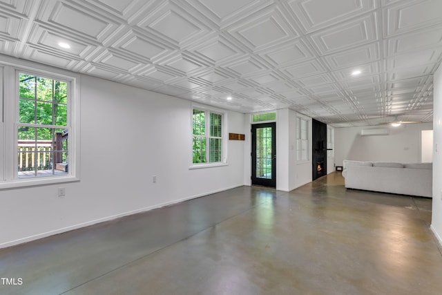 85 Christenbury Ln, Clayton, NC 27527 - interior space featuring concrete flooring, a wall mounted air conditioner, an ornate ceiling, recessed lighting, and baseboards