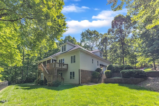 85 Christenbury Ln, Clayton, NC 27527 - view of home's exterior with a wooden deck, fence, brick siding, a lawn, and stairway
