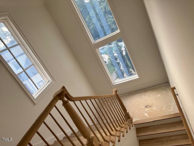 1216 Barcroft Pl, Raleigh, NC 27615 - staircase with healthy amount of natural light and a towering ceiling