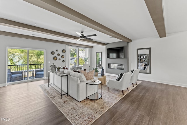 1245 S Blount St Unit 201, Raleigh, NC 27601 - living area featuring wood finished floors, baseboards, and beam ceiling