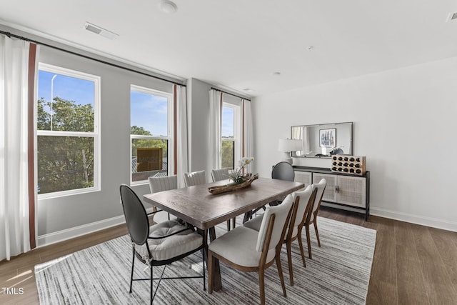 1245 S Blount St Unit 201, Raleigh, NC 27601 - dining area with visible vents, baseboards, and wood finished floors