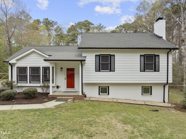 2949 Tram Rd, Fuquay Varina, NC 27526 - tri-level home featuring a chimney, roof with shingles, and a front lawn