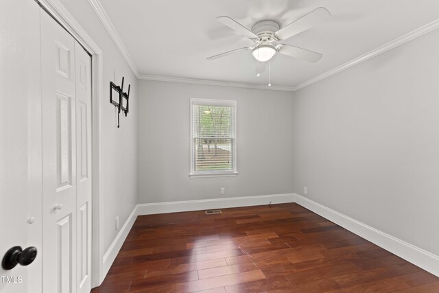 2949 Tram Rd, Fuquay Varina, NC 27526 - empty room with crown molding, dark wood-style flooring, baseboards, visible vents, and ceiling fan