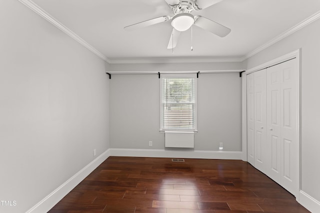 2949 Tram Rd, Fuquay Varina, NC 27526 - unfurnished bedroom featuring a closet, baseboards, ornamental molding, wood finished floors, and a ceiling fan