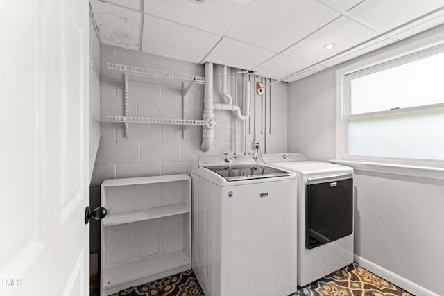 2949 Tram Rd, Fuquay Varina, NC 27526 - washroom with baseboards, concrete block wall, laundry area, and separate washer and dryer