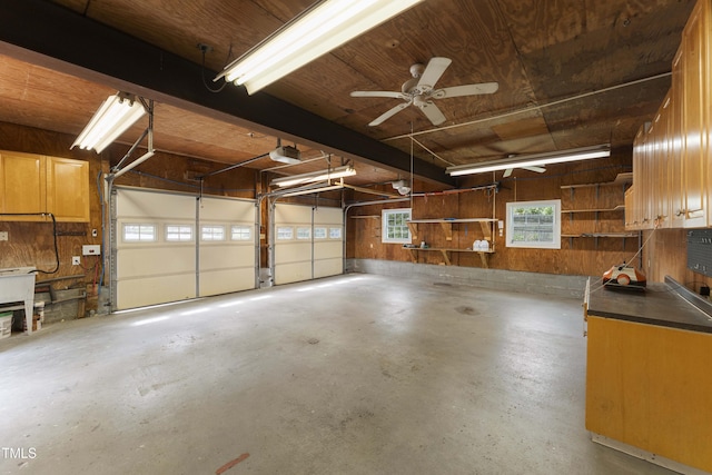 2949 Tram Rd, Fuquay Varina, NC 27526 - garage with wooden walls, ceiling fan, and a garage door opener
