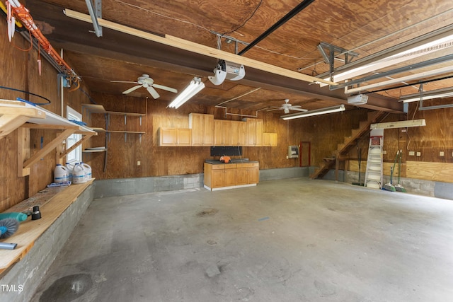 2949 Tram Rd, Fuquay Varina, NC 27526 - garage featuring a garage door opener, wood walls, and ceiling fan