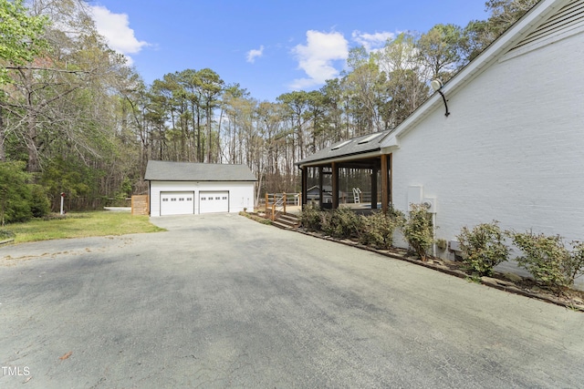 2949 Tram Rd, Fuquay Varina, NC 27526 - view of side of property featuring an outbuilding, a garage, and a yard