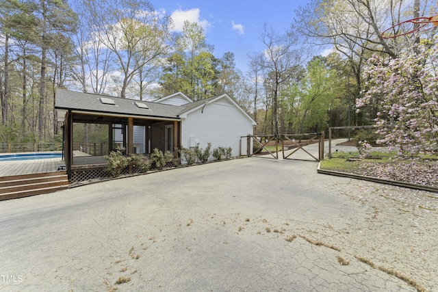 2949 Tram Rd, Fuquay Varina, NC 27526 - view of side of property featuring driveway, a gate, a shingled roof, and an outdoor pool