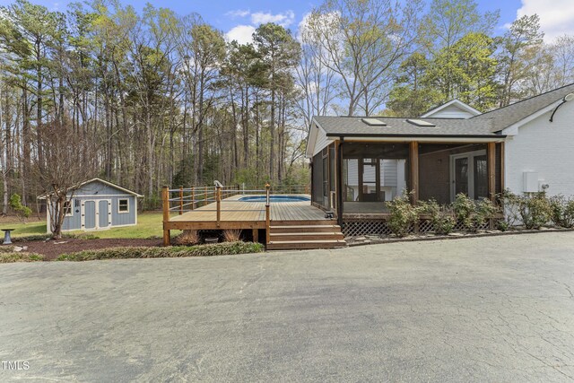 2949 Tram Rd, Fuquay Varina, NC 27526 - view of front facade with an outdoor structure, a deck, and brick siding