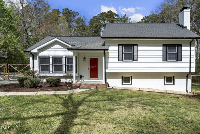 2949 Tram Rd, Fuquay Varina, NC 27526 - tri-level home with a shingled roof, a chimney, and a front lawn