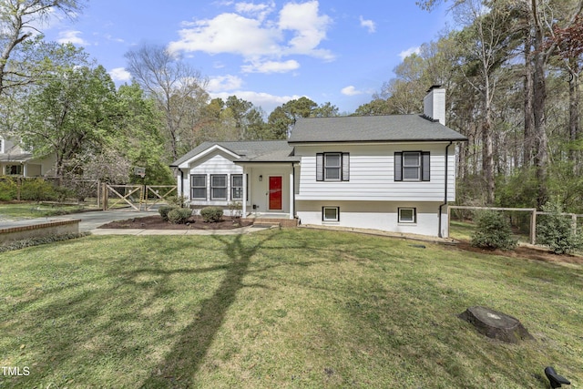 2949 Tram Rd, Fuquay Varina, NC 27526 - split level home with a chimney, fence, and a front lawn