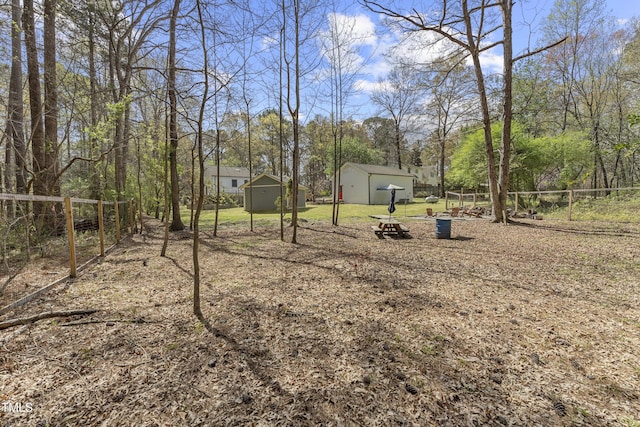 2949 Tram Rd, Fuquay Varina, NC 27526 - view of yard with a storage unit, an outbuilding, and fence