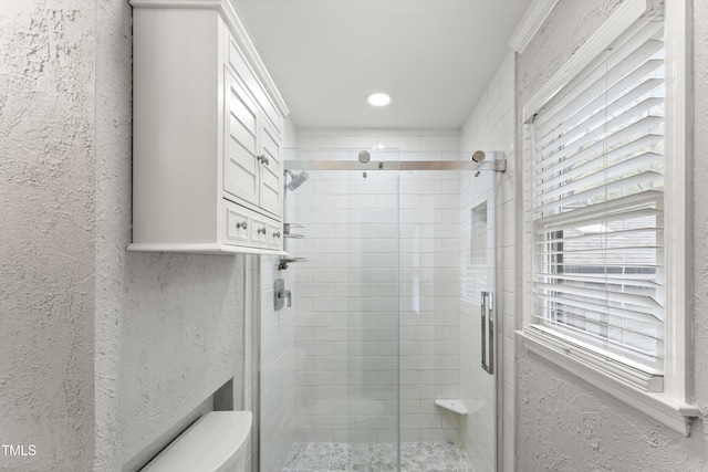 2949 Tram Rd, Fuquay Varina, NC 27526 - bathroom with toilet, a textured wall, and a shower stall