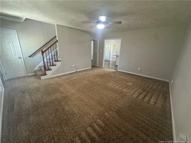 5870 Mcdonald Rd, Parkton, NC 28371 - unfurnished living room featuring a textured ceiling, visible vents, baseboards, carpet flooring, and stairs