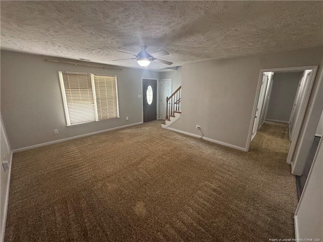 5870 Mcdonald Rd, Parkton, NC 28371 - unfurnished living room featuring carpet flooring, a textured ceiling, stairs, a ceiling fan, and baseboards