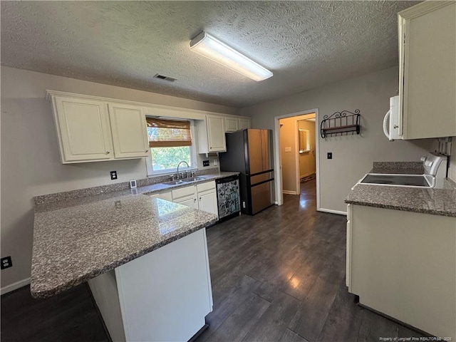 5870 Mcdonald Rd, Parkton, NC 28371 - kitchen featuring range with electric stovetop, visible vents, a sink, white cabinets, and freestanding refrigerator