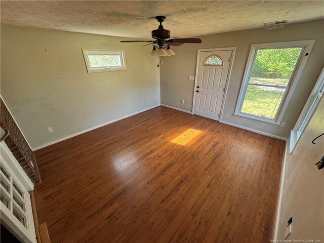 5870 Mcdonald Rd, Parkton, NC 28371 - foyer featuring a textured ceiling, baseboards, visible vents, and wood finished floors
