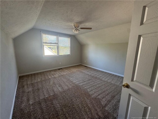 5870 Mcdonald Rd, Parkton, NC 28371 - additional living space with carpet flooring, a textured ceiling, a ceiling fan, baseboards, and lofted ceiling