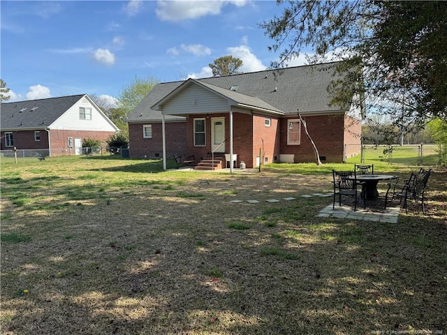 5870 Mcdonald Rd, Parkton, NC 28371 - rear view of property with fence, brick siding, crawl space, entry steps, and a lawn