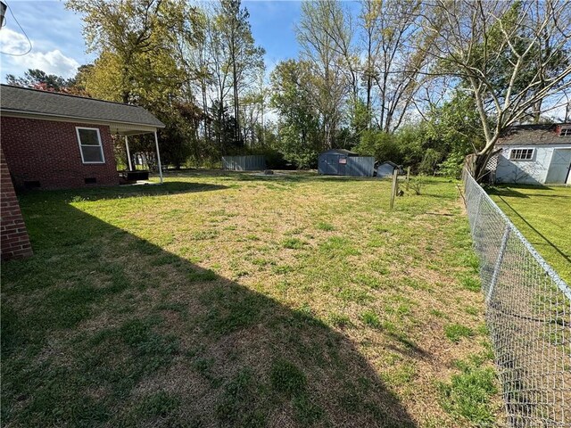 5870 Mcdonald Rd, Parkton, NC 28371 - view of yard with a storage shed, fence, and an outdoor structure