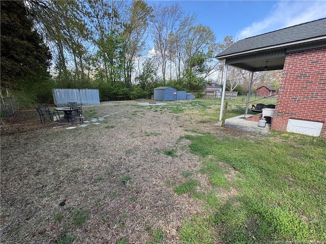 5870 Mcdonald Rd, Parkton, NC 28371 - view of yard with a storage shed, fence, an outdoor structure, and a patio area