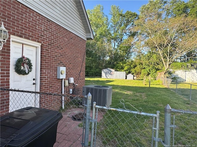 5870 Mcdonald Rd, Parkton, NC 28371 - view of side of home featuring a storage shed, central AC unit, brick siding, fence, and a yard