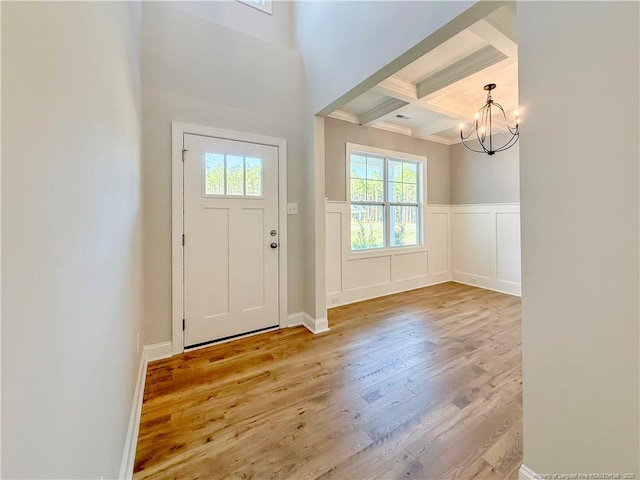 1312 Cory Cir, Fayetteville, NC 28312 - doorway to outside featuring wainscoting, wood finished floors, beamed ceiling, coffered ceiling, and a notable chandelier
