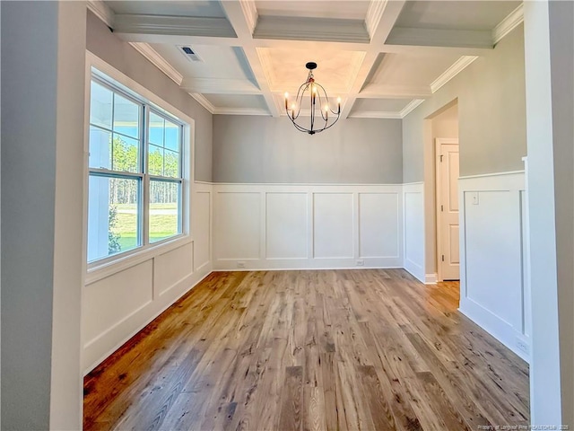 1312 Cory Cir, Fayetteville, NC 28312 - unfurnished dining area with an inviting chandelier, visible vents, a decorative wall, beamed ceiling, and light wood finished floors