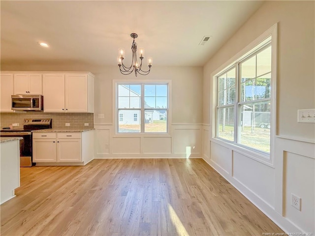 1312 Cory Cir, Fayetteville, NC 28312 - kitchen with an inviting chandelier, visible vents, light wood-style floors, white cabinetry, and appliances with stainless steel finishes