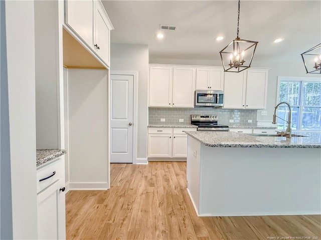 1312 Cory Cir, Fayetteville, NC 28312 - kitchen with decorative backsplash, visible vents, appliances with stainless steel finishes, a sink, and a chandelier