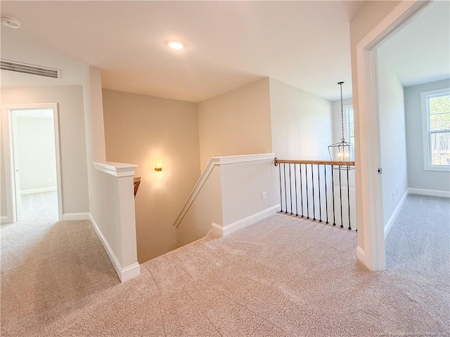 1312 Cory Cir, Fayetteville, NC 28312 - hallway with baseboards, visible vents, carpet flooring, and an upstairs landing