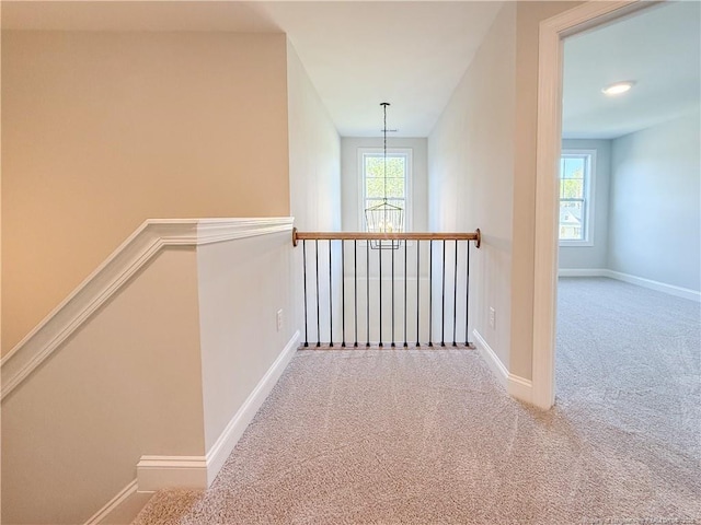 1312 Cory Cir, Fayetteville, NC 28312 - corridor featuring carpet floors, baseboards, a chandelier, and an upstairs landing