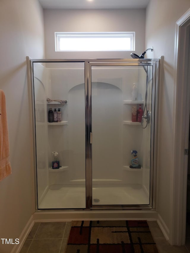 17 Verona Dr, Clayton, NC 27527 - bathroom with a shower stall, tile patterned floors, and baseboards