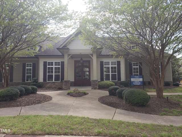 17 Verona Dr, Clayton, NC 27527 - view of front facade featuring roof with shingles, french doors, and stone siding