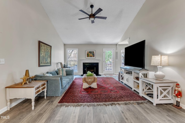 9512 Anson Grove Ln, Raleigh, NC 27615 - living room with a ceiling fan, high vaulted ceiling, baseboards, and wood finished floors