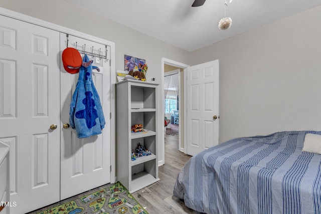 9512 Anson Grove Ln, Raleigh, NC 27615 - bedroom with a ceiling fan, a textured ceiling, and wood finished floors