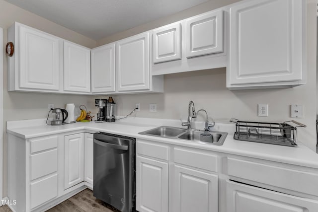 9512 Anson Grove Ln, Raleigh, NC 27615 - kitchen with white cabinets, a sink, wood finished floors, and stainless steel dishwasher
