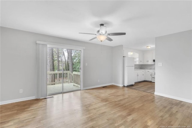 unfurnished living room featuring light wood-style flooring, ceiling fan, baseboards, and visible vents