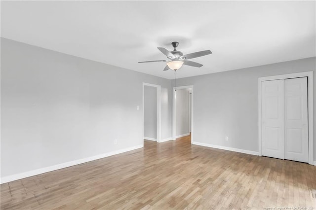 interior space with ceiling fan, light wood-style floors, and baseboards