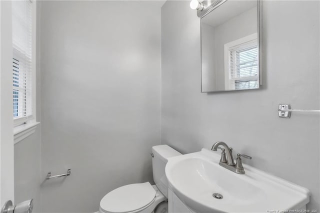 half bathroom with a sink and toilet