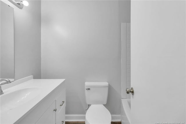 full bathroom featuring toilet, vanity, and baseboards