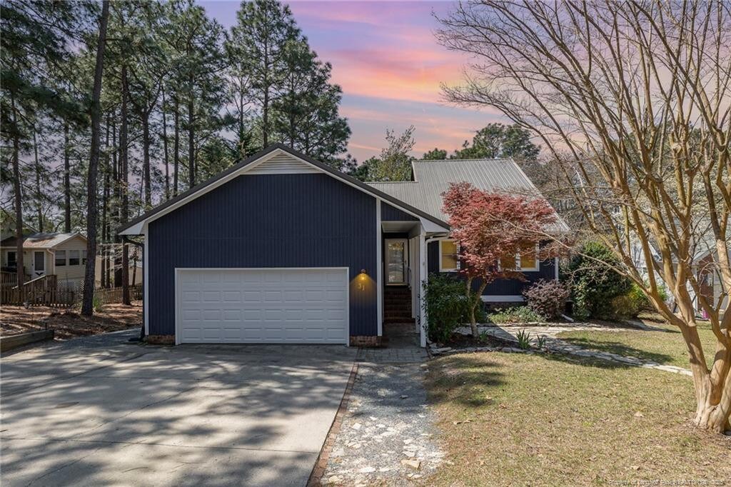 31 Woodbury Ln, Sanford, NC 27332 - view of front facade with concrete driveway and an attached garage