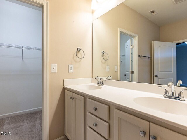 112 Churment Ct, Durham, NC 27703 - full bath with double vanity and baseboards