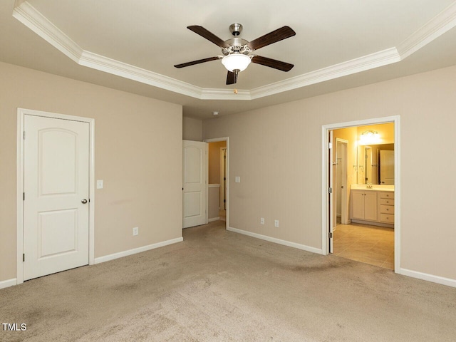 112 Churment Ct, Durham, NC 27703 - unfurnished bedroom featuring a tray ceiling, crown molding, light carpet, ensuite bath, and ceiling fan